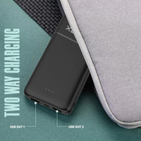 Black two-way charging device with USB ports on a gray surface