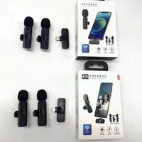 Set of black lavalier microphones with packaging on a white background