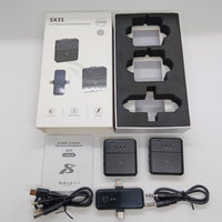 Wireless microphone system with packaging and accessories on a white background