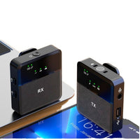 Two black electronic devices labeled 'TX' and 'RX' on a reflective surface.