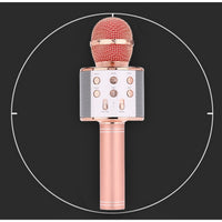 Rose gold wireless microphone on a black background