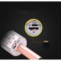 Rose gold microphone with USB connector and TF card on a black background