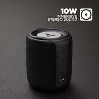 Black portable speaker with '10W Immersive Stereo Sound' text on a dark background