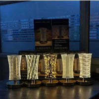 Five decorative LED lamps on a desk with a cityscape in the background